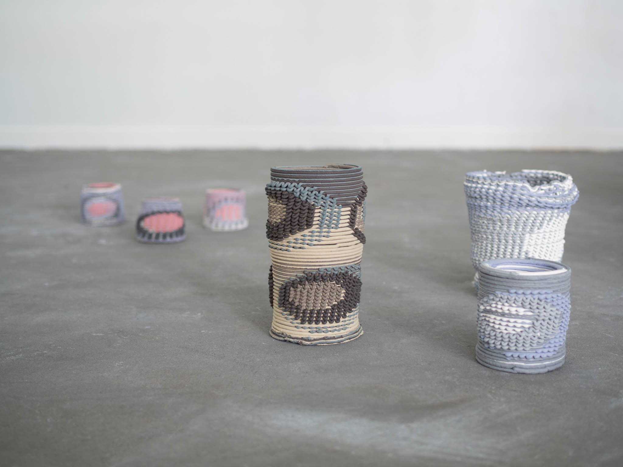 collection of woven ceramic vases