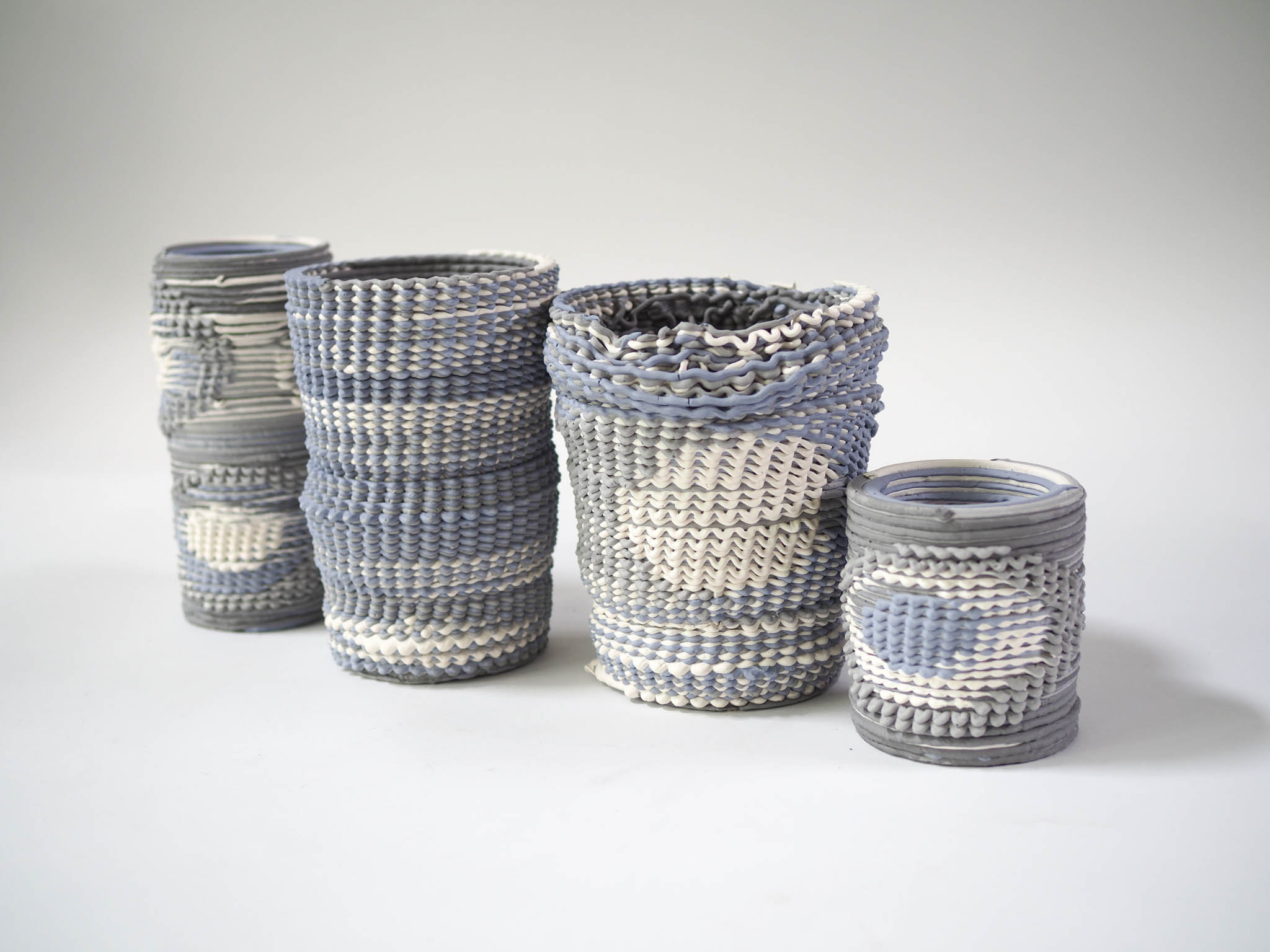 collection of woven ceramic vases